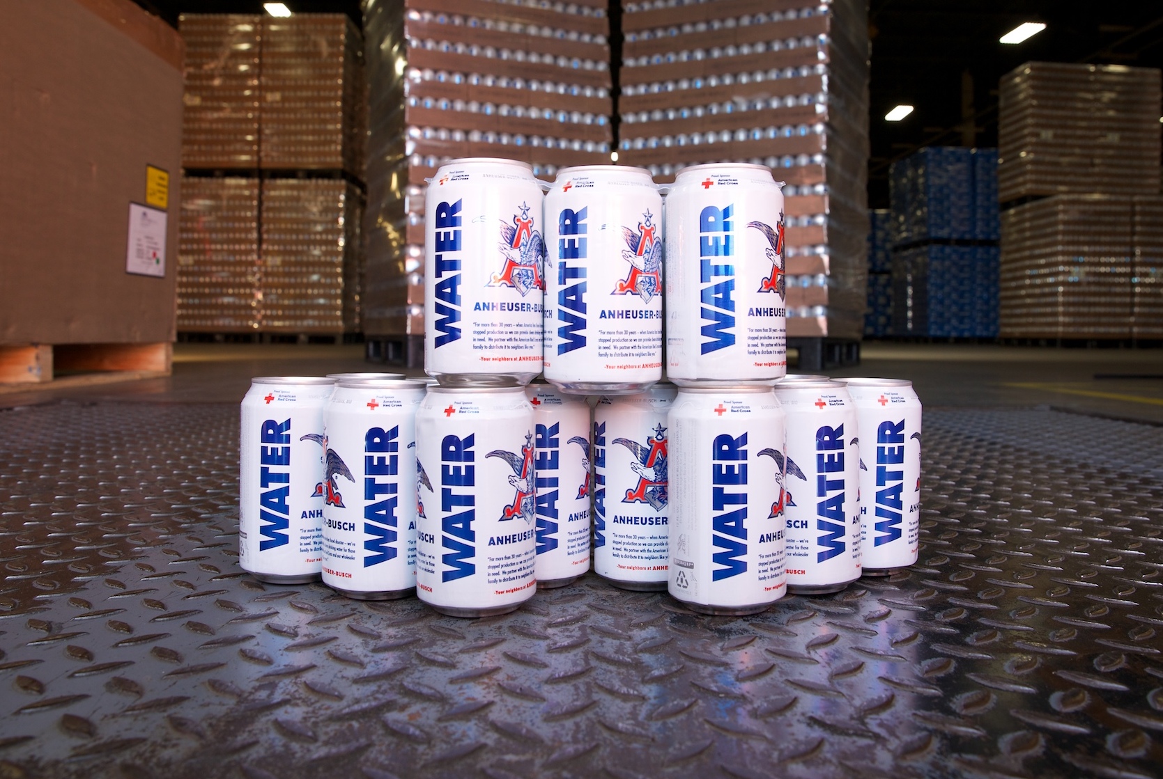 Stack of Anheuser-Busch emergency drinking water cans on the floor of a factory