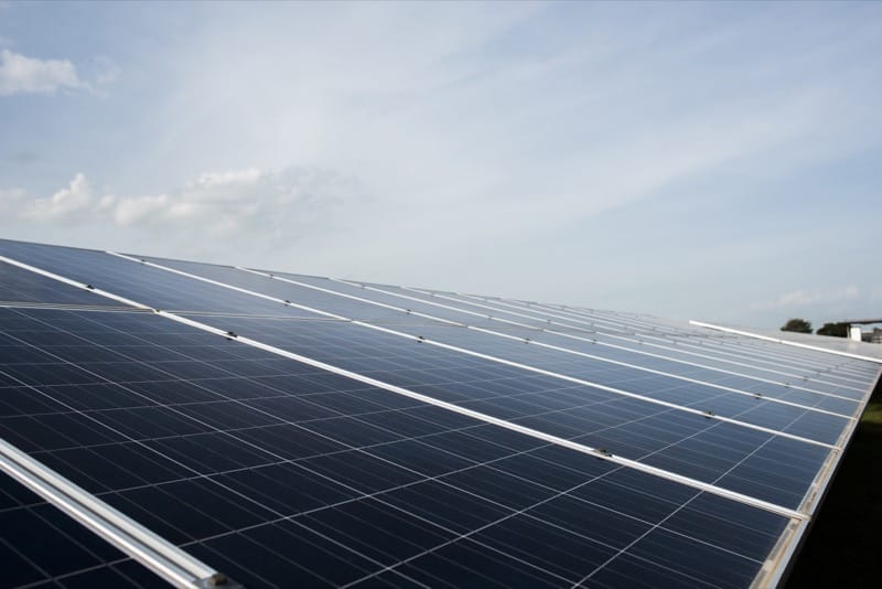 Solar panels under a cloudy sky